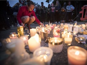 Candles are placed to commemorate victims of Friday's shooting, outside the Al Noor mosque in Christchurch, New Zealand, Monday, March 18, 2019.