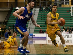 The University of Alberta Golden Bears' Tyus Jefferson (2) battles the UBC Thunderbirds' Patrick Simon (11) during Game 3 of their Canada West playoff series, in Edmonton on Sunday, Feb. 24, 2019.