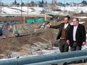 Minister of Service Alberta Brian Malkinson, left, and Transportation Minister Brian Mason walk along a pathway above Deerfoot Trail in Calgary on Thursday, March 14, 2019. The provincial government has announced major upgrades to the busy thoroughfare.