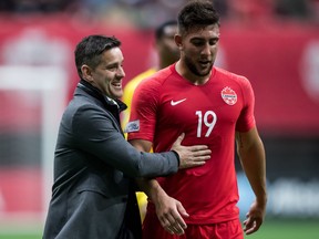 Canada head coach John Herdman, left, and Lucas Cavallini walk off the field after the first half of a Concacaf Nations League qualifying soccer match against French Guiana in Vancouver, on Sunday March 24, 2019. Canada won 4-1.