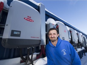 Mike Bryant, Aquatic Maintenance with the Town of Barrhead, with power inverters that are hooked to solar panels on the town's aquatic centre which were paid for with money collected from the carbon tax.