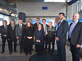 Group involved in the LRT project pose with government officials after the announcement of over $1 billion in federal funding for Valley Line West and Metro Line Northwest projects, at Lewis Farm Transit Centre Monday in Edmonton.