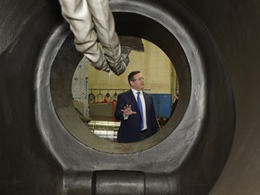 Alberta UCP Leader Jason Kenney is seen through an oil and gas pipeline valve talking to employees at Universe Machine Co. on Wednesday March 6, 2019, where Kenney announced how his party will cut red tape to help create jobs in Alberta if elected in the upcoming provincial election.