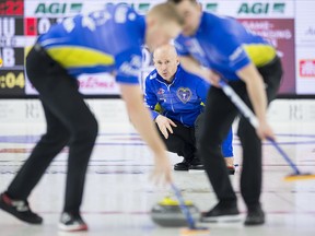 Team Alberta skip Kevin Koe looks on as lead Ben Hebert and second Colton Flasch sweep against Team Nunavut at the Brier in Brandon, Man. Wednesday, March 6, 2019. (THE CANADIAN PRESS/Jonathan Hayward)