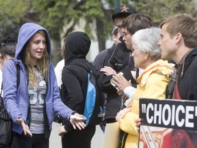 ***FREELANCE PHOTO - POSTMEDIA NETWORK USE ONLY*** Calgary, AB  -- June 8, 2011 -- Abortion Protest   - Grade 12 student Jessica Sedgwick discusses the issues with members of the Canadian Centre for Bio-Ethical Reform at an abortion protest outside Jack James Public High School in Calgary. Sedgwick says the conversation changed her views but she still believes abortions should be available in some situations. Photo by Keith Morison for National Post