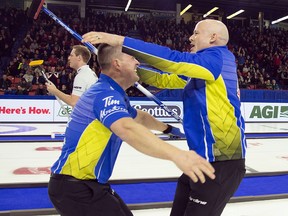 Team Alberta skip Kevin Koe (right) celebrates his win over Team Wild Card with lead Ben Hebert in the final draw at the Brier in Brandon, Man. Sunday, March 10, 2019.
