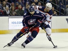Edmonton Oilers forward Connor McDavid, right, controls the puck against Columbus Blue Jackets defenseman Seth Jones during the first period of an NHL hockey game in Columbus, Ohio, Saturday, March 2, 2019.