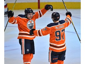 Edmonton Oilers Connor McDavid (97) celebrates with Leon Draisaitl (29) after scoring a hit trick against the Calgary Flames during the season opener of NHL action at Rogers Place in Edmonton, October 4, 2017.