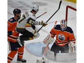 Vegas Golden Knights Max Pacioretty (67) leaping in the air to screen Edmonton Oilers goalie Mikko Koskinen (19) as Darnell Nurse (25) trails the play during NHL action at Rogers Place in Edmonton, December 1, 2018.