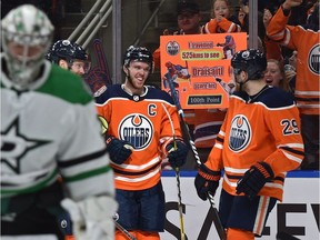 Edmonton Oilers Connor McDavid (97) celebrates his goal with Leon Draisaitl (29) on Dallas Stars goalie Anton Khudobin (35) during NHL action at Rogers Place in Edmonton, March 28, 2019.