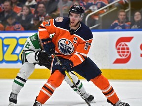 Edmonton Oilers Connor McDavid (97) heads up ice being chased by Dallas Stars Radek Faksa (12) during NHL action at Rogers Place in Edmonton, March 28, 2019.