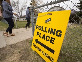 People enter a polling station at Meadowlark Christian School in the Edmonton-Meadowlark riding in Edmonton, Alta, on May 5, 2015 during Alberta's 2015 provincial election.