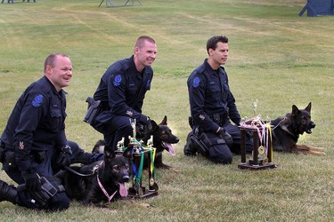 Edmonton Canine's Scott Mitchler (c) and Jack, Dennis Dalzeil (l) and Kane and Ryan Busby (r) with Jagger pose for photos. At the annual Canadian Police Canine Association dog trials, Edmonton canine unit took home third, fourth and fifth place overall. The friendly competition took place in Kelowna from September 10 to 14, 2014. Three EPS Canine Unit officers and their police service dogs competed against 24 handlers from law enforcement agencies across Canada in areas of obedience, agility, tracking, building searches, compound searches, evidence search and criminal apprehension.  The Edmonton Canine Unit helped a press conference to show off their hardware In Edmonton on Thursday, Sept. 18, 2014.  Perry Mah, Edmonton Sun/QMI Agency
