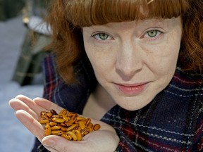 Kelly Gilliam holds a handful of Pepa de Zapallo beans. She created her own seed bank, named Populuxe Seed Bank, with 400 varieties of often rare seeds that all grow well in the Edmonton climate simply as a way to celebrate what she loves and help preserve biodiversity. She relies on volunteers to help grow the seeds and refresh the stock.