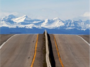 Alberta Provincial Highway 23 stretches toward High River, south of Calgary with the Rocky Mountains in the background on Wednesday May 3, 2017.