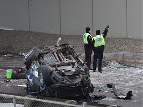 Police investigate on the scene of where a pickup truck fell off the Anthony Henday bridge down onto Parsons Rd. in Edmonton, March 12, 2019.