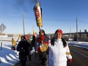 Marlene Poitras carries the Canada Winter Games Roly McLenahan Torch on Tuesday, Jan. 8, 2019 near the Alberta legislature in Edmonton. The torch was on its way to Red Deer for the Canada Winter Games which are from February 15 until March 3, 2019. Red Deer and central Alberta will welcome the nation for the 2019 Canada Winter Games.
