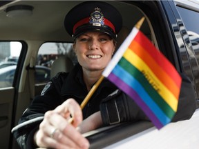 Edmonton Police Service Const. Chelsea Elmquist, seen with her cruiser on Wednesday, April 3, 2019, is a member of the LGBTQ community and has served as a police officer for nine years. She proudly marched in Edmonton's Pride Parade last year that was halted due to protest.