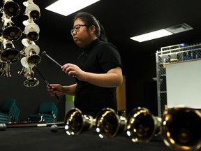 Isabela Ramos is graduating from Concordia University of Edmonton with a major in hand bells, the first Canadian to do so. She's seen playing hand bells in the music room inside Ralph King Athletic Centre at Concordia in Edmonton, on Wednesday, April 3, 2019. Photo by Ian Kucerak/Postmedia