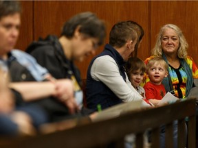 Kids and their family watch the Batman v. Robin children's mock arbitration held during Law Day at the Edmonton Law Courts in Edmonton, on Saturday, April 13, 2019. The day allows the public to learn about the justice system in a fun environment from judges, lawyers and members of the judicial staff.