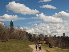 A couple jog with their baby at Government House Park on a warm spring day in Edmonton, on Tuesday, April 16, 2019.