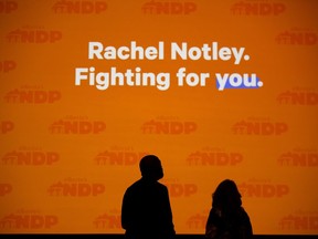 NDP Edmonton-City Centre MLA David Shepherd and Alberta NDP president Peggy Wright stand on the stage as they prepare to MC the Alberta NDP's election night at the Edmonton Convention Centre on April 16, 2019.