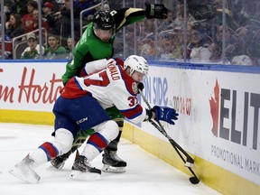 The Edmonton Oil Kings' Conner McDonald (37) battles the Prince Albert Raiders' Zack Hayes (5) during Game 4 of the WHL Eastern Conference Championship second period action at Rogers Place, in Edmonton Wednesday April 24, 2019.