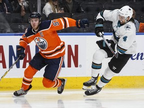 San Jose Sharks' Brenden Dillon (4) chases Edmonton Oilers' Connor McDavid (97) during second period NHL action in Edmonton, Alta., on Thursday April 4, 2019.