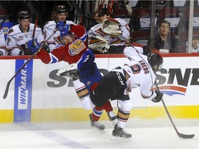 Calgary Hitmen, Dakota Krebs battles Edmonton Oil Kings, Vince Loschiavo in first period WHL Eastern Conference Semi-Final action at the Scotiabank Saddledome in Calgary on Tuesday, April 9, 2019. Darren Makowichuk/Postmedia