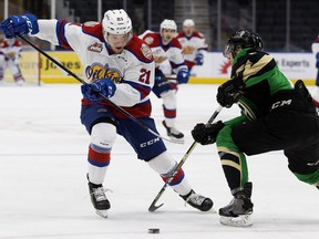 The Edmonton Oil Kings' Jake Neighbours (21) battles the Prince Albert Raiders' Brayden Pachal (8) during Game 4 of the WHL Eastern Conference Championship first period action at Rogers Place, in Edmonton Wednesday April 24, 2019. Photo by David Bloom