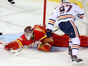 Calgary Flames goalie Mike Smith makes a save on a shot by Connor McDavid of the Edmonton Oilers during NHL hockey at the Scotiabank Saddledome in Calgary on Saturday, April 6, 2019.