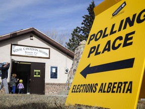 A voter arrives with his children to cast a ballot at a rural poling station in Cremona, Alta., Tuesday, April 16, 2019.