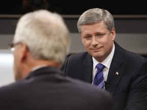 Prime Minister Stephen Harper listens to Liberal leader Stephane Dion during the French language debate at the National Arts Centre in Ottawa, Ontario, October 1, 2008.