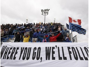 FC Edmonton fans sing the national anthem during an Al Classico exhibition game between FC Edmonton Academy and Calgary Foothills at Clarke Stadium in Edmonton, on Sunday, April 29, 2018.