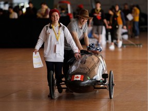 Carter Trautmann, back, moves the University of Alberta prototype eco-car Sofie into position during day one of the Shell Eco-Marathon Americas competition.