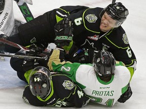 Prince Albert Raiders Brett Leason is checked by Edmonton Oil Kings Wyatt McLeod (top) and Carter Souch (bottom) during third period WHL hockey game action in Edmonton on Nov. 28, 2018.