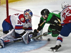 Edmonton Oil Kings goalie Todd Scott (35) loses the rebound as Jalen Luypen (23) trips up Prince Albert Raiders Spencer Moe (11) during WHL action at Rogers Place in Edmonton opn Monday, Feb. 4, 2019.