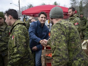 Prime Minister Justin Trudeau greets Canadian Forces members as they assist with flood relief efforts in the Ottawa community of Constance Bay on Saturday, April 27, 2019.