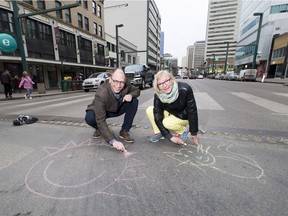 Paths for People chairman Dave Buchanan and volunteer Theresa Agnew on Jasper Avenue, which the organization hopes to shut for a street festival on Aug. 25.