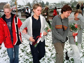 Four young women come to pay tribute to shooting victim Jason Lang at W. R. Myers High School in Taber, Alta., Thursday, April 29, 1999.