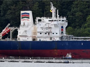 An oil tanker dwarfs an accompanying security vessel at Kinder Morgan's Trans-Mountain marine terminal, in Burnaby, B.C., on Tuesday, May 29, 2018.