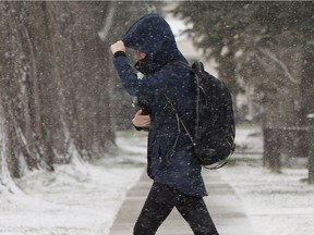 A Concordia University of Edmonton student makes their way to class during a spring snowstorm in Edmonton, on Tuesday, April 30, 2019.