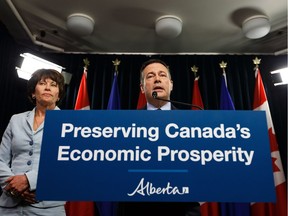 Premier Jason Kenney (right) speaks beside Energy Minister Sonya Savage about Bill 12, the turn-off-the-taps legislation, during a press conference in the media room in the Alberta Legislature in Edmonton, on Wednesday, May 1, 2019.