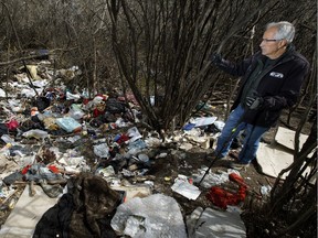 Bill McGowan looks at garbage in Dawson Park near Jasper Avenue and 84 Street in Edmonton on Thursday, May 2, 2019.
