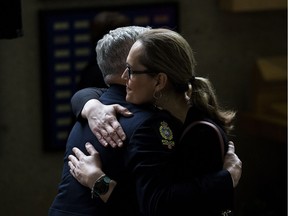 Edmonton Police Service (EPS) Superintendent Brad Doucette is hugged by LGBTQ activist Marni Panas following a ceremony where EPS formally apologized to the LGBTQ2S+ community, at Edmonton Police Headquarters Friday May 3, 2019. The apology is part of a reconciliation process with the EPS and members of the lesbian, gay, bisexual, trans, queer, and two-spirit community.