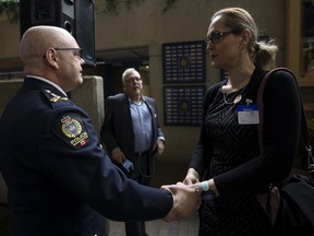 Edmonton Police Service Chief Dale McFee shakes hands with LGBTQ activist Marni Panas after McFee apologized to the LGBTQ2S+ community at Edmonton Police Headquarters, in Edmonton on Friday, May 3, 2019. The apology is part of a reconciliation process with the EPS and members of the lesbian, gay, bisexual, trans, queer, and two-spirit community.