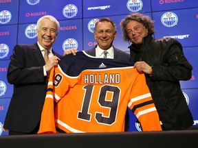 (Left to right) Bob Nicholson, CEO and Vice Chair of Oilers Entertainment Group, Ken Holland, general manager of the Edmonton Oilers, and Daryl Katz, owner of the Edmonton Oilers, celebrate Holland's hiring as the team's new general manager at Rogers Place in Edmonton, on Tuesday, May 7, 2019.