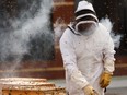 MacEwan University urban beekeeper Troy Donovan unwraps the university's hives for the season on the roof of Building 5 in Edmonton, on Thursday, May 16, 2019.