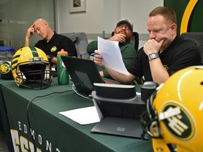 Eskimos general manager Brock Sunderland (R), director of player personnel David Turner and head coach Jason Maas (L) in the war room for the 2019 CFL Draft at Commonwealth Stadium in Edmonton, May 2, 2019.