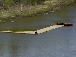 A man sits on a dock on the bank of the North Saskatchewan River in southwest Edmonton on Friday May 17, 2019.